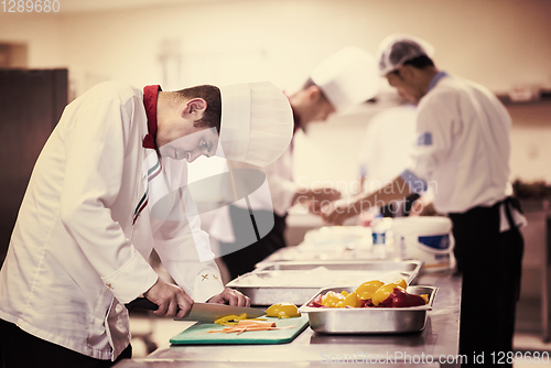Image of Chef cutting fresh and delicious vegetables