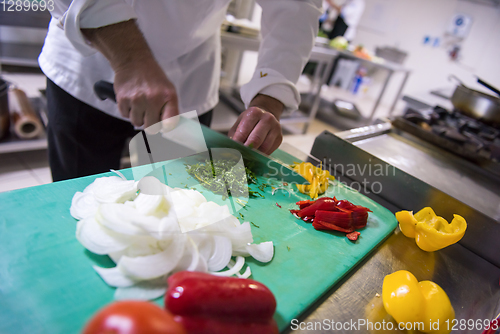 Image of Chef hands cutting fresh and delicious vegetables