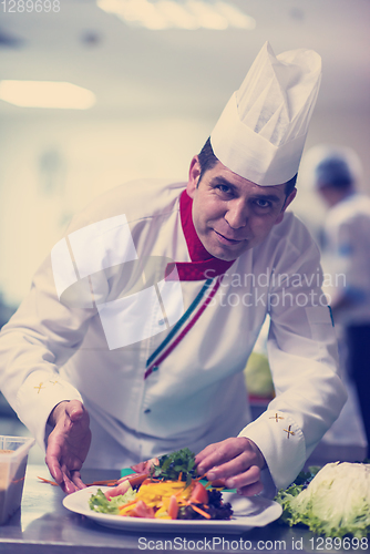 Image of chef serving vegetable salad