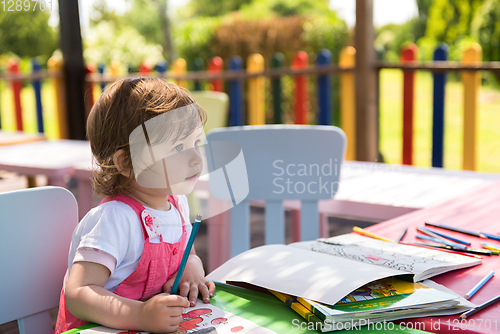 Image of little girl drawing a colorful pictures