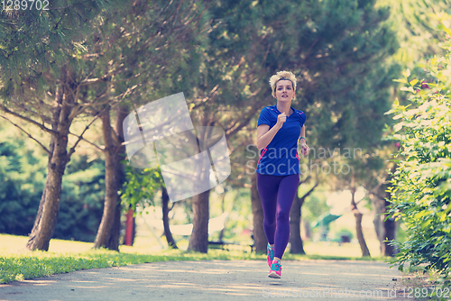 Image of young female runner training for marathon