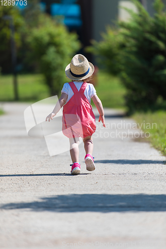 Image of little girl runing in the summer Park