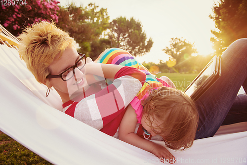 Image of mom and a little daughter relaxing in a hammock