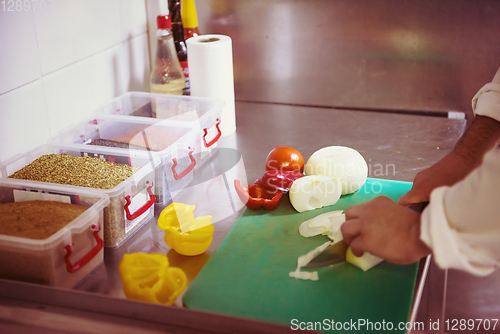 Image of Chef hands cutting fresh and delicious vegetables