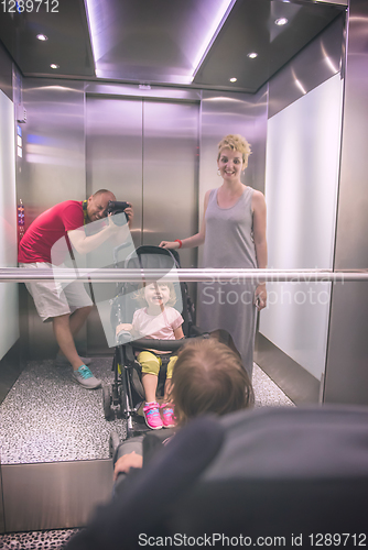 Image of happy family in the elevator