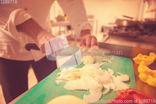 Image of Chef hands cutting fresh and delicious vegetables