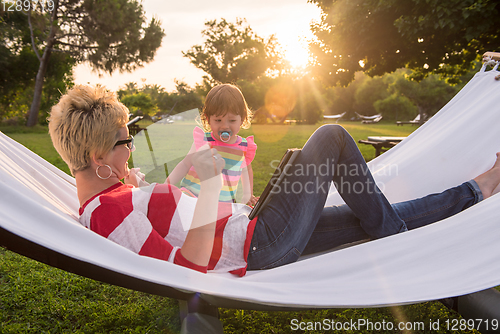 Image of mom and a little daughter relaxing in a hammock