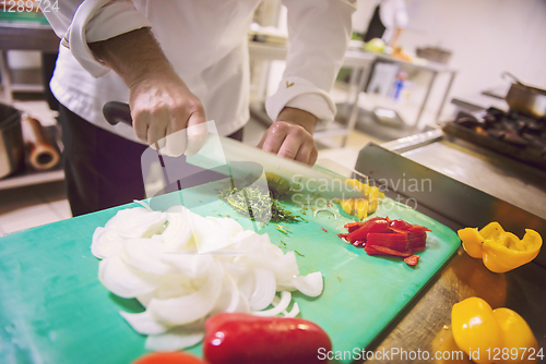 Image of Chef hands cutting fresh and delicious vegetables