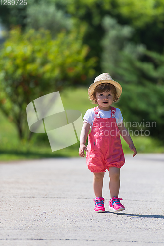 Image of little girl runing in the summer Park