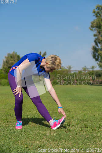 Image of female runner warming up and stretching