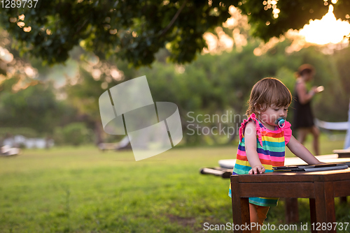 Image of little girl spending time at backyard