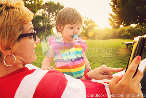 Image of mom and a little daughter relaxing in a hammock