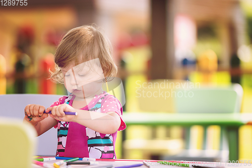 Image of little girl drawing a colorful pictures