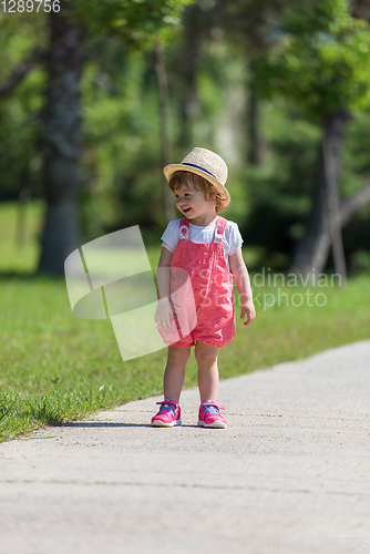 Image of little girl runing in the summer Park