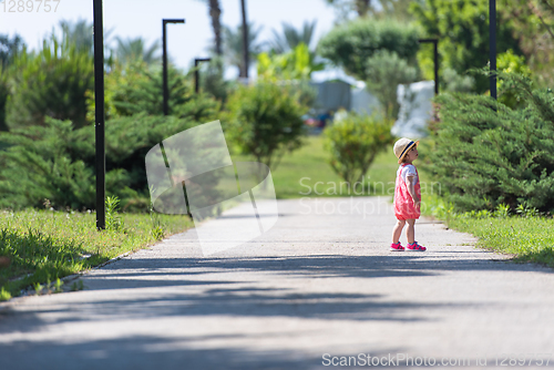 Image of little girl runing in the summer Park