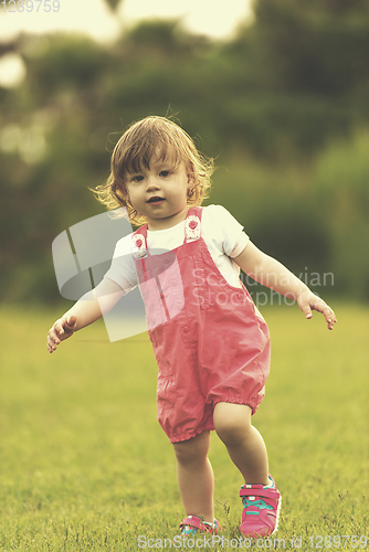 Image of little girl spending time at backyard