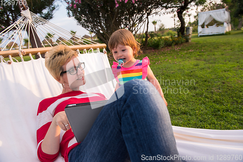 Image of mom and a little daughter relaxing in a hammock