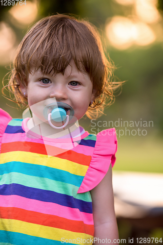 Image of little girl spending time at backyard