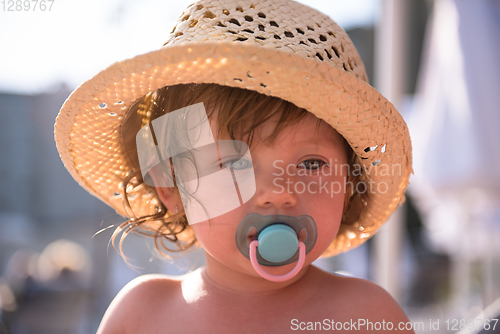 Image of tired little girl resting on sunbed