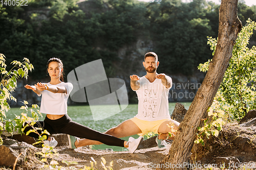 Image of Young couple having fun and spending time at riverside in sunny day