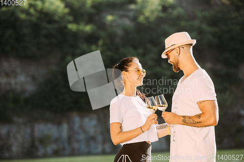 Image of Young couple having fun and spending time at riverside in sunny day