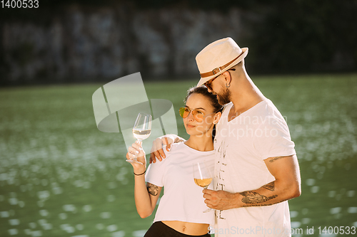 Image of Young couple having fun and spending time at riverside in sunny day