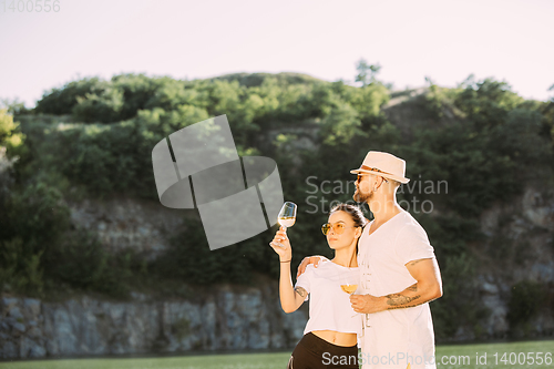 Image of Young couple having fun and spending time at riverside in sunny day