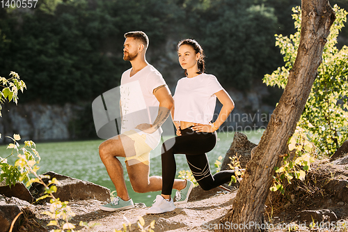 Image of Young couple having fun and spending time at riverside in sunny day