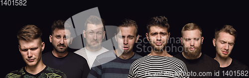 Image of Close up portrait of young men isolated on black studio background