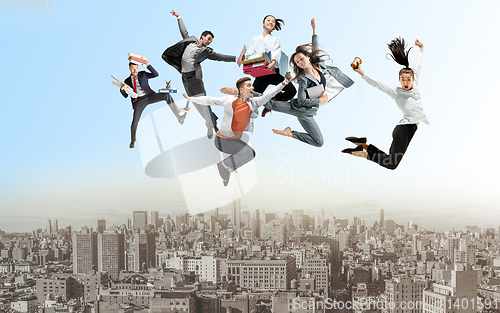 Image of Office workers or ballet dancers jumping above the city