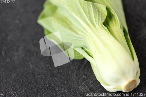 Image of close up of bok choy cabbage on slate background