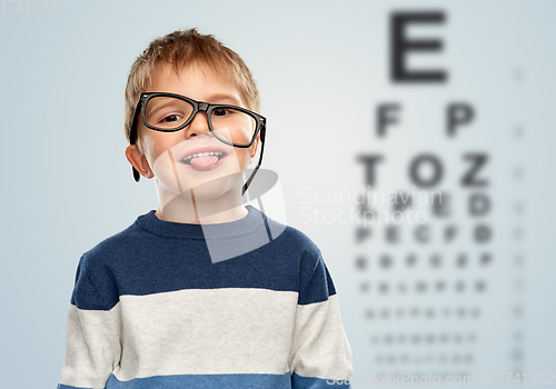 Image of little boy in glasses showing tongue