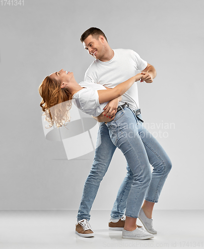 Image of portrait of happy couple in white t-shirts dancing