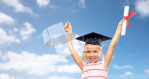 Image of happy little girl in mortarboard with diploma