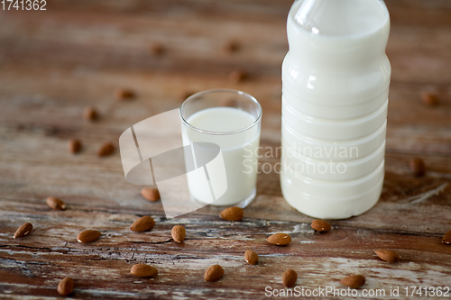 Image of milk and almonds on wooden table