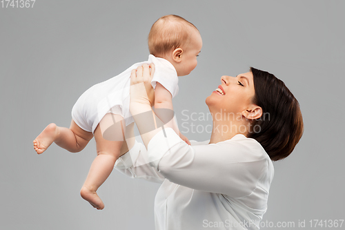 Image of happy middle-aged mother with little baby daughter