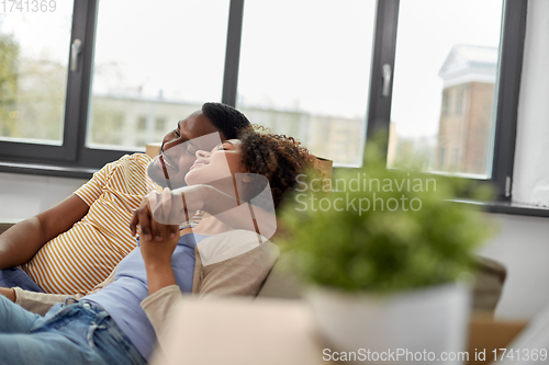 Image of happy couple moving to new home and hugging