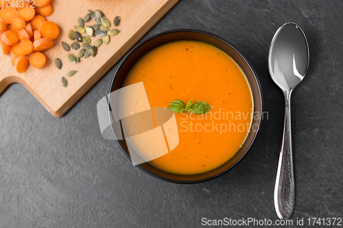 Image of vegetable pumpkin cream soup in bowl with spoon