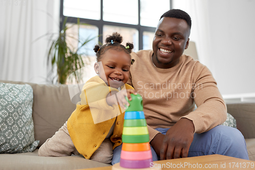 Image of african family playing with baby daughter at home