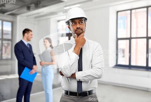 Image of indian male architect in helmet at office room