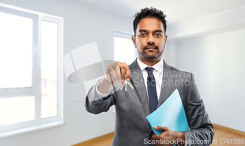 Image of indian man realtor with home keys and folder