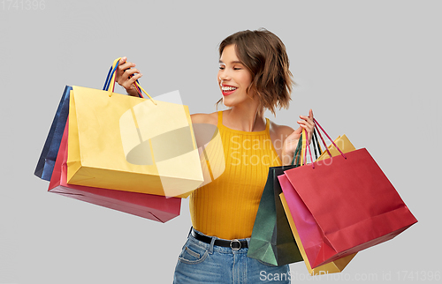 Image of happy smiling young woman with shopping bags