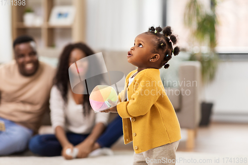 Image of african american baby girl with ball at home