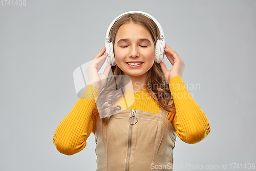 Image of teenage girl in headphones listening to music