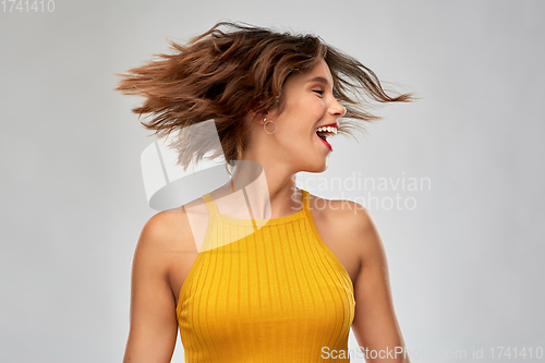 Image of happy young woman shaking head