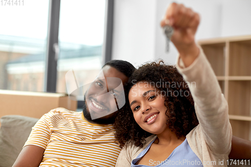 Image of happy couple with house key moving to new home