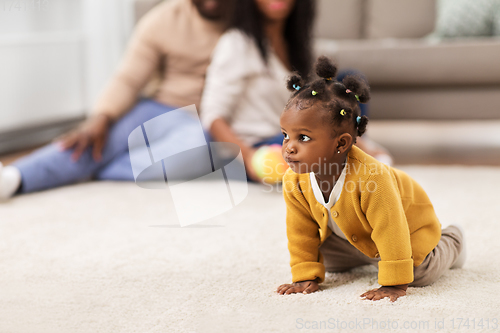 Image of african american baby crawling on floor at home