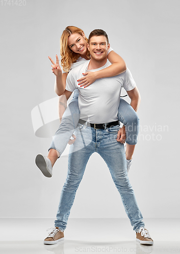 Image of happy couple in white t-shirts having fun