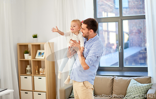 Image of father with little baby daughter at home