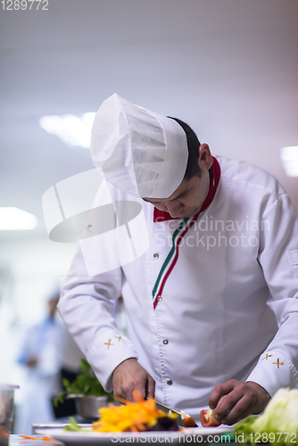 Image of chef serving vegetable salad